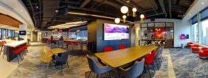 a sleek, modern office with a stylish conference table, surrounded by diverse professionals engaged in a dynamic strategy discussion, showcasing a digital display of impressive analytics and growth metrics indicative of a successful seo campaign.